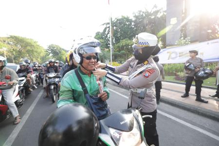 Gatur Lalin Sambil Berbagi Helm dan Co
